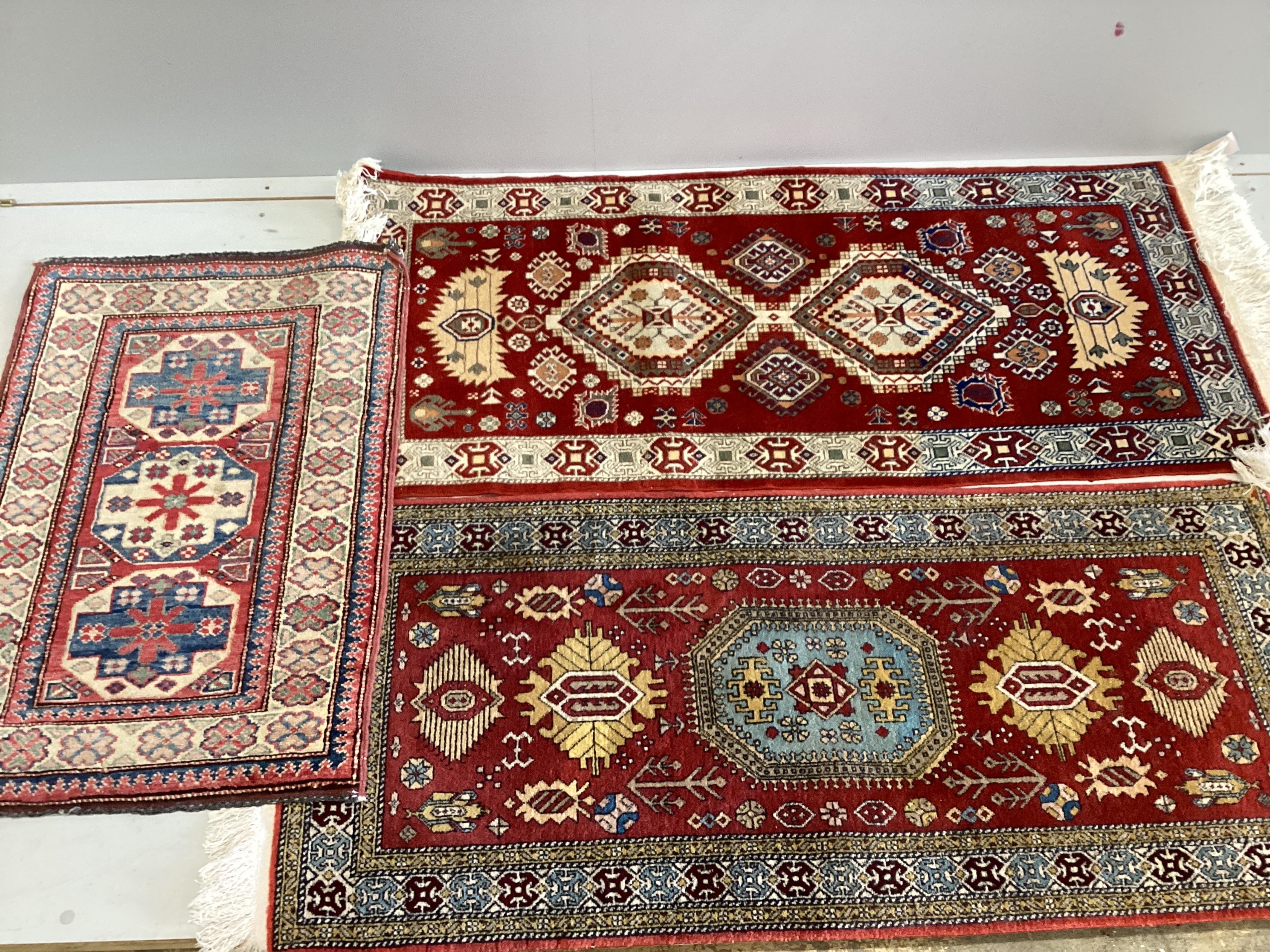 Three assorted modern Persian rugs, largest 139 x 61cm. Condition - one faded, the other two good